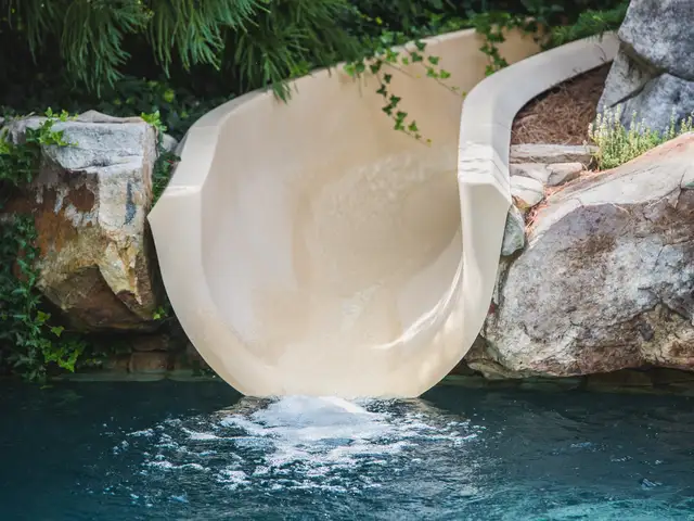 Pool waterslide built by Waterscapes Backyard Resorts in Middle Tennessee