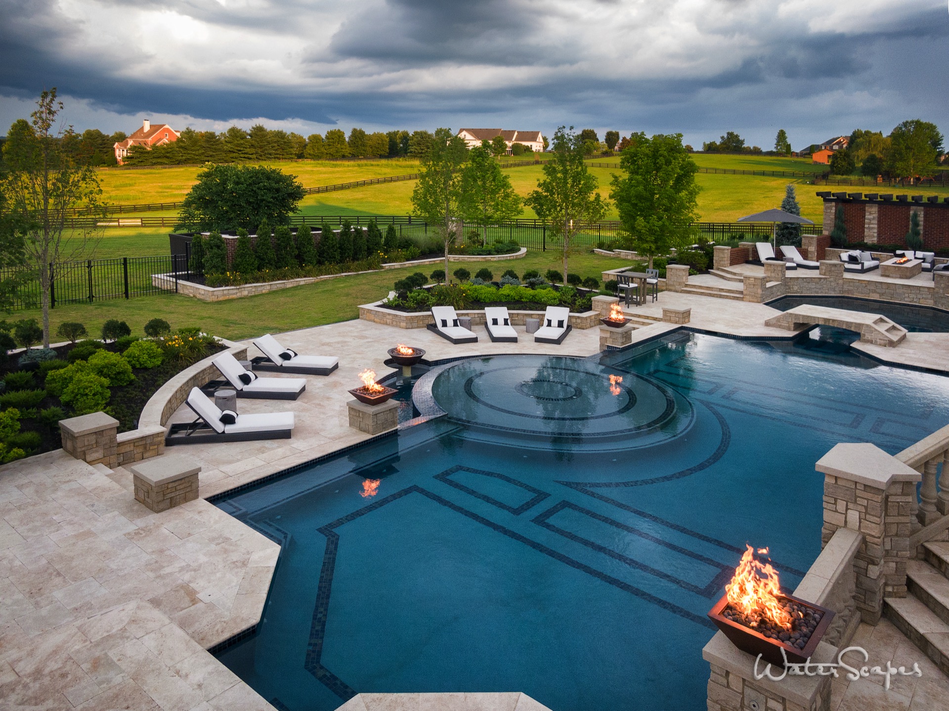 Resort-style pool with fire features, lounge chairs, and full outdoor living area in Nashville