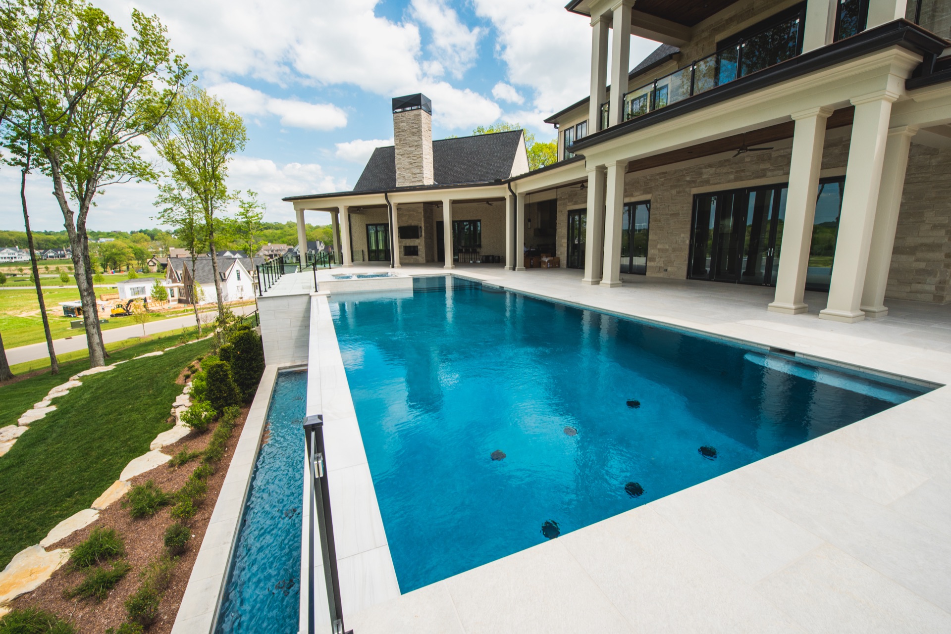 Modern rectangular gunite pool with luxury estate and outdoor living area in Nashville